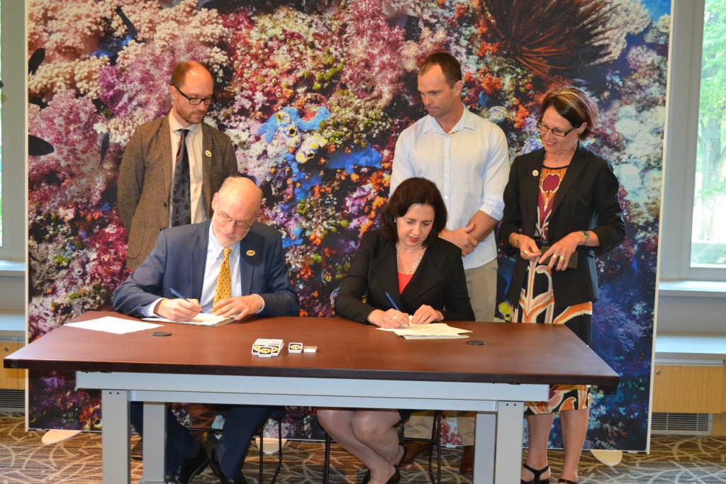 Smithsonian Deputy Undersecretary for Collections and Interdisciplinary Support, Scott Miller and Australian State of Queensland Premier, Annastacia Palaszczuk, sign MOU Document. Also pictured are three Smithsonian Queensland fellows. From the left Dr. Mark Shutze, Dr. Aaron Davis, and Dr. Kathryn Mackey.